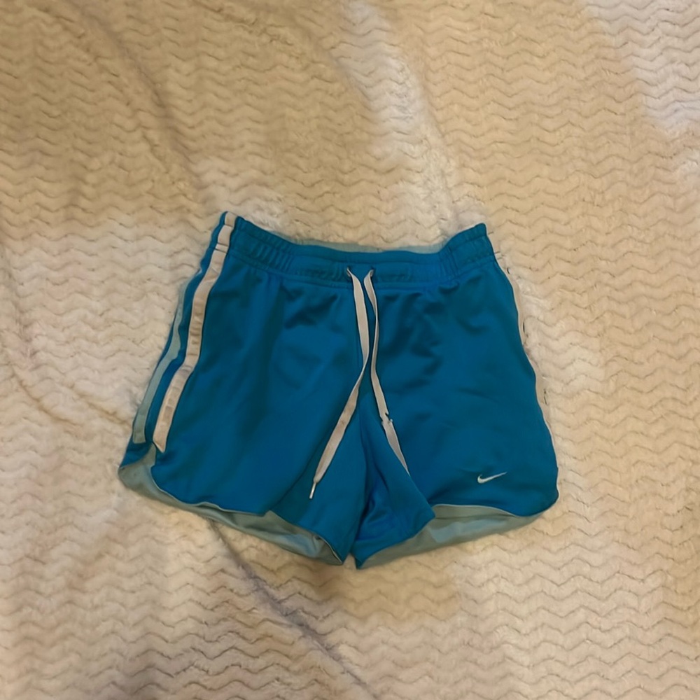Blue Nike shorts with adjustable graw strings worn